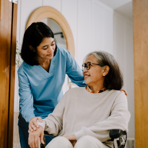 A Caregiver posing with Elderly Woman